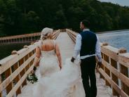 bride and groom on bridge